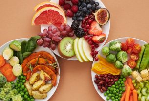 Top view of vibrant plates of fresh fruits and vegetables, perfect for a healthy lifestyle.
